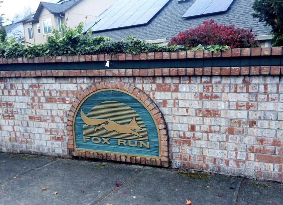 Fox Run entrance sign set into a brick wall